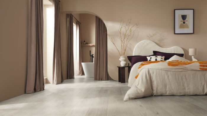 Karndean Designflooring Clay Artisan Oak LVT wood flooring in a bedroom