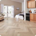 Herringbone patterned luxury vinyl flooring in a light wood tone.