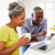 Older couple reading FAQs on a laptop