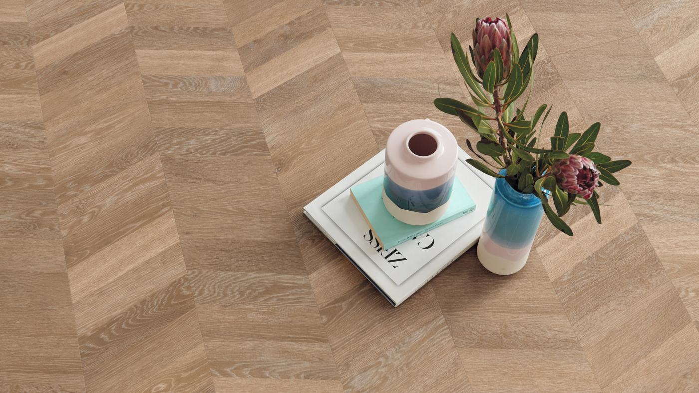 Pale Limed Oak floors in a chevron pattern from our Knight Tile collection can be installed as gluedown (CH-KP94) or rigid core (SCB-CH-KP94)