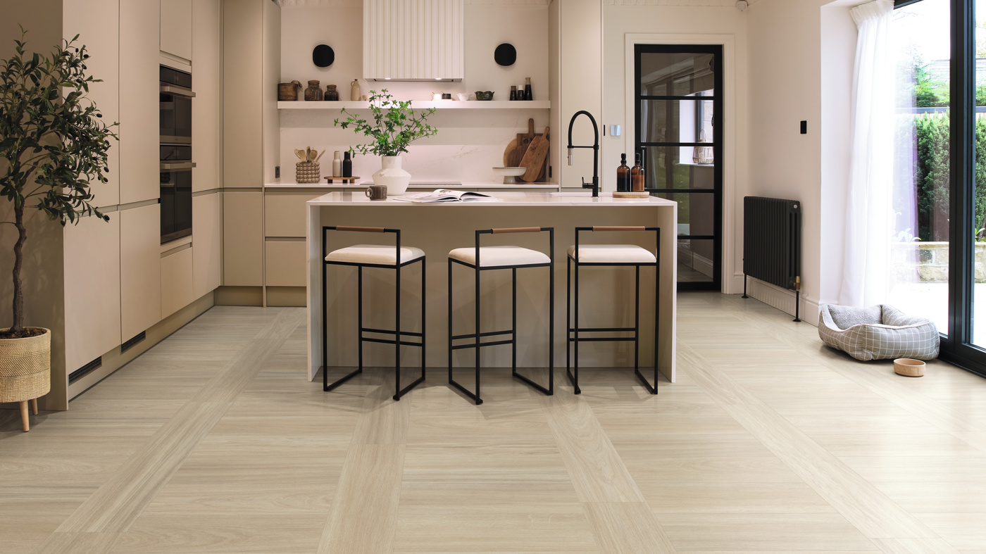 Rhine Oak lvt floors in a broken straight lay pattern add subtle interest to this kitchen