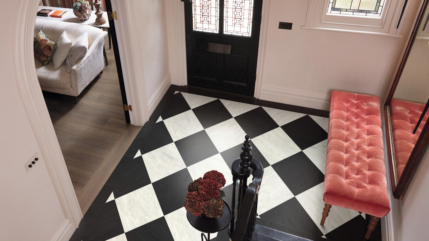 Corinthian Marble LM31 and Doric Marble LM32 in a diamond pattern in an entryway with Serrano Oak RL28 floors in the adjacent living room