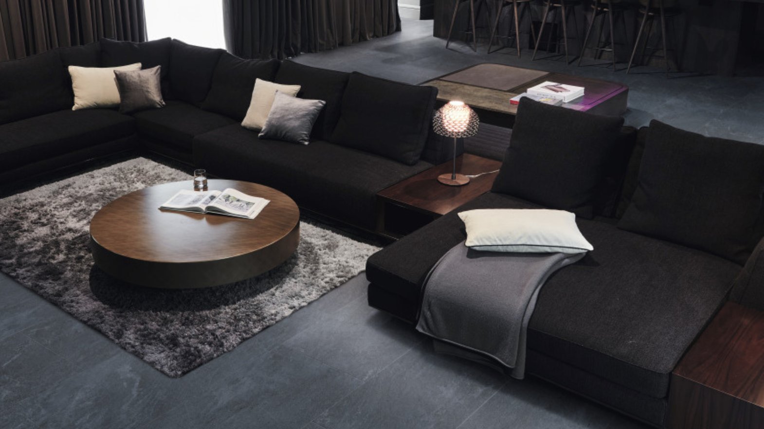 A moody living room channels the In CTRL design aesthetic with its Lago Quartzite floors