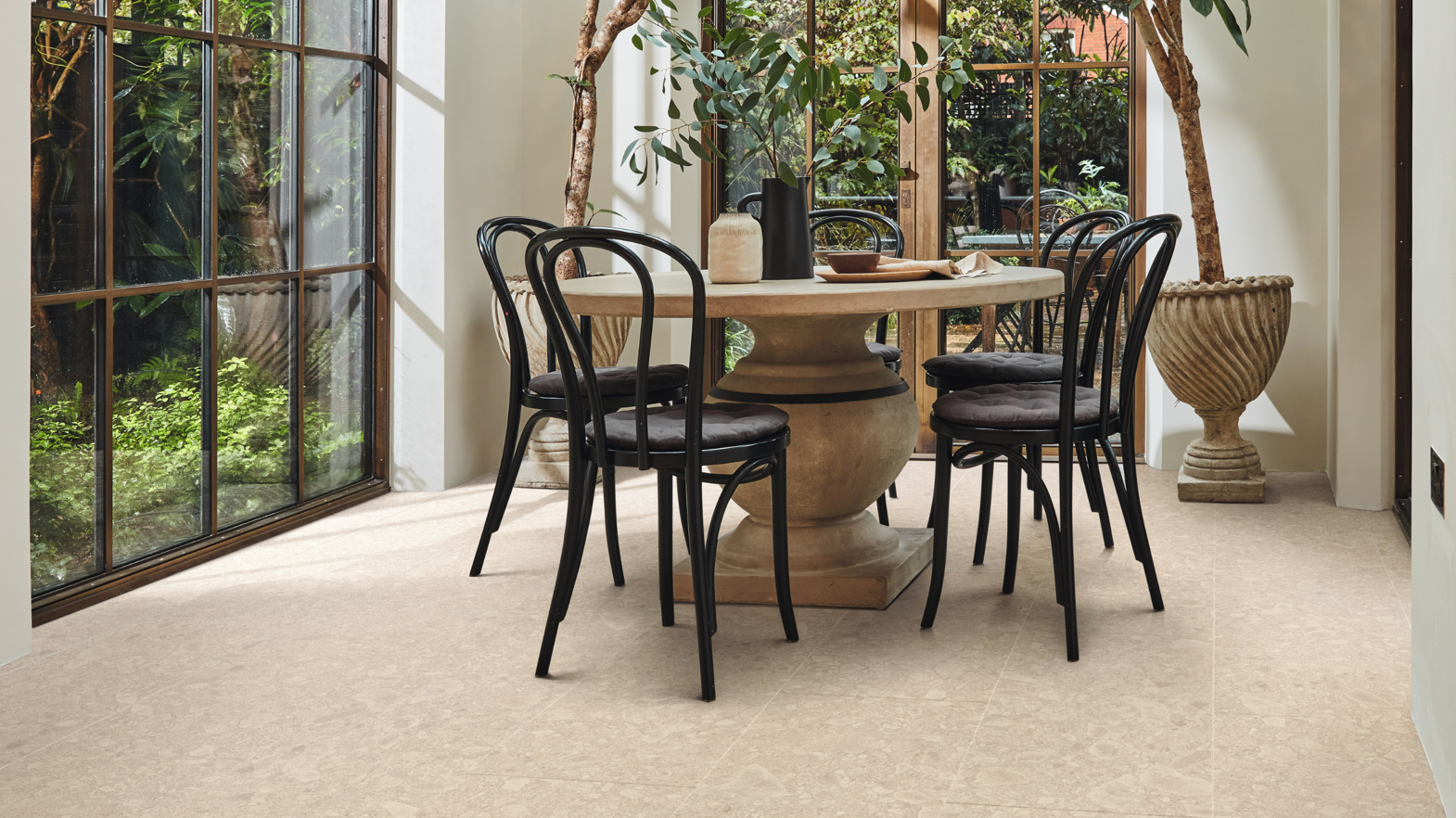 A dining room embodies the Prana design aesthetic with it's Sabbia Ceppo floors