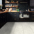 Bianco Breccia Marble RKT3021-G floors from the Korlok Select collection in a black kitchen