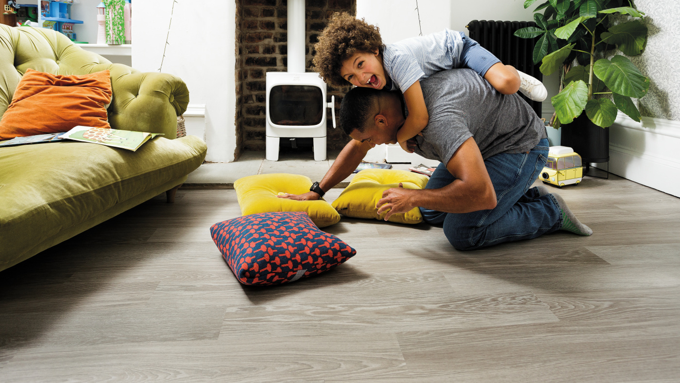 Father and son wrestling on Grey Limed Oak floors in their living room