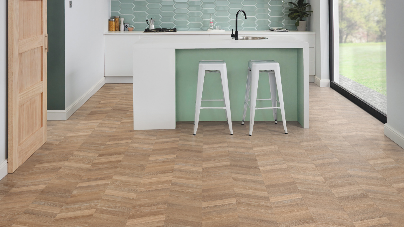 Pale Limed Oak lvp floors in a chevron pattern add personality to the kitchen; available for installation in gluedown and rigid core
