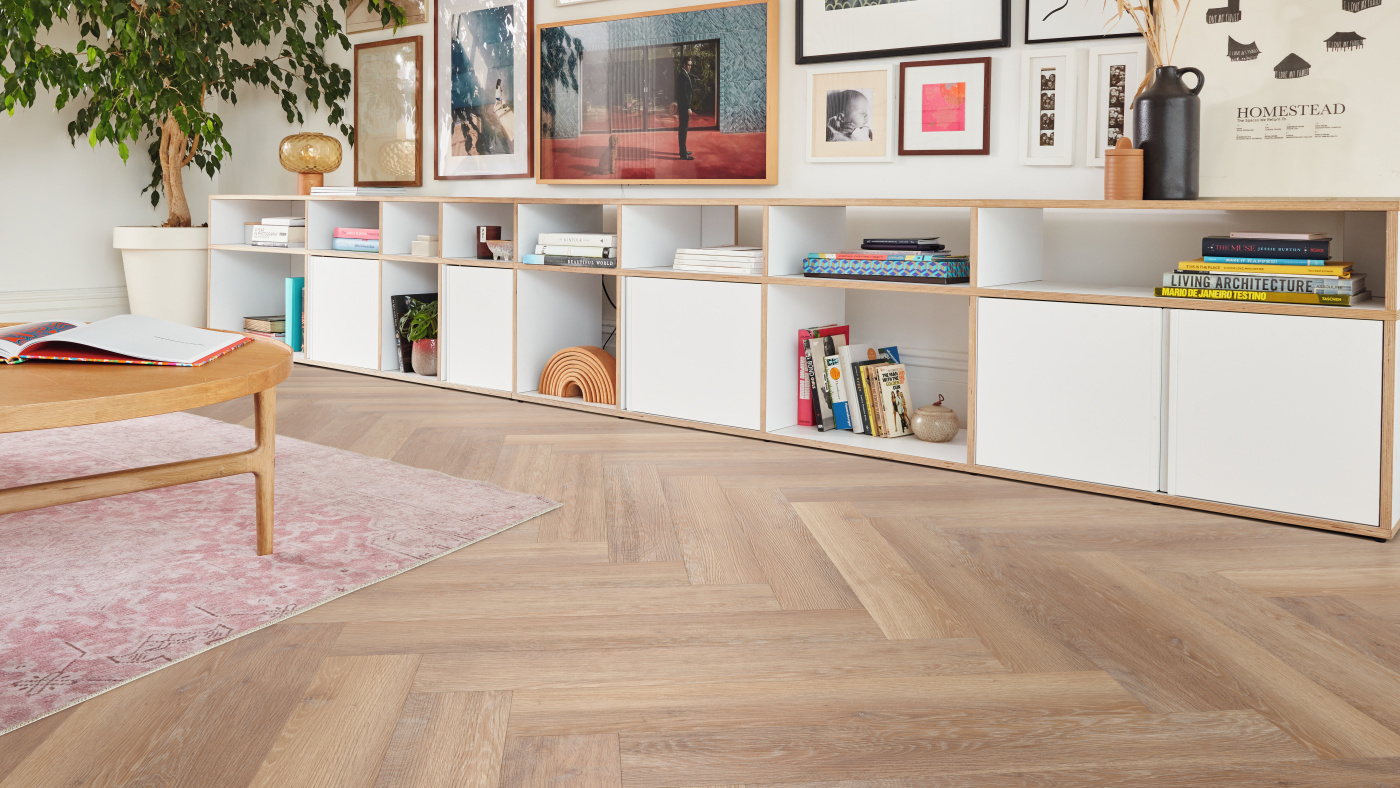 Pale Limed Oak herringbone lvp floors pattern add classic charm to a living room; available for installation in gluedown and rigid core